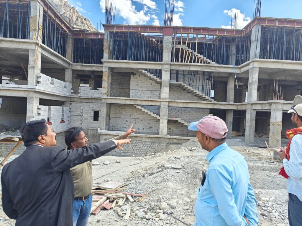 Prof. Kushwaha reviewing construction site with officials at Kargil Campus