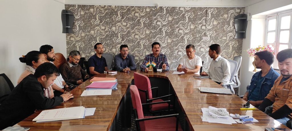 Officials discussing digital land records and domicile issuance in Khaltse